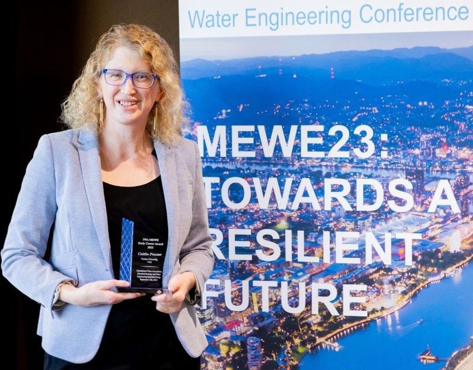 Caitlin Proctor accepts the 2023 the Early Career Research Award in Microbial Ecology and Water Engineering from the International Water Association